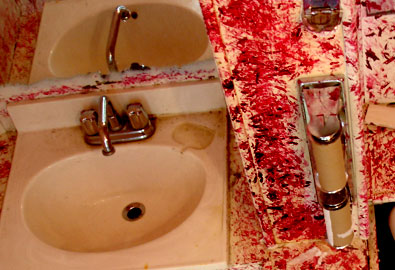 red fingernail polish on the walls of a toilet